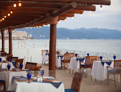 Arrangement of dining tables with ocean view in Sunset Restaurant at Buenaventura Grand Hotel and Spa