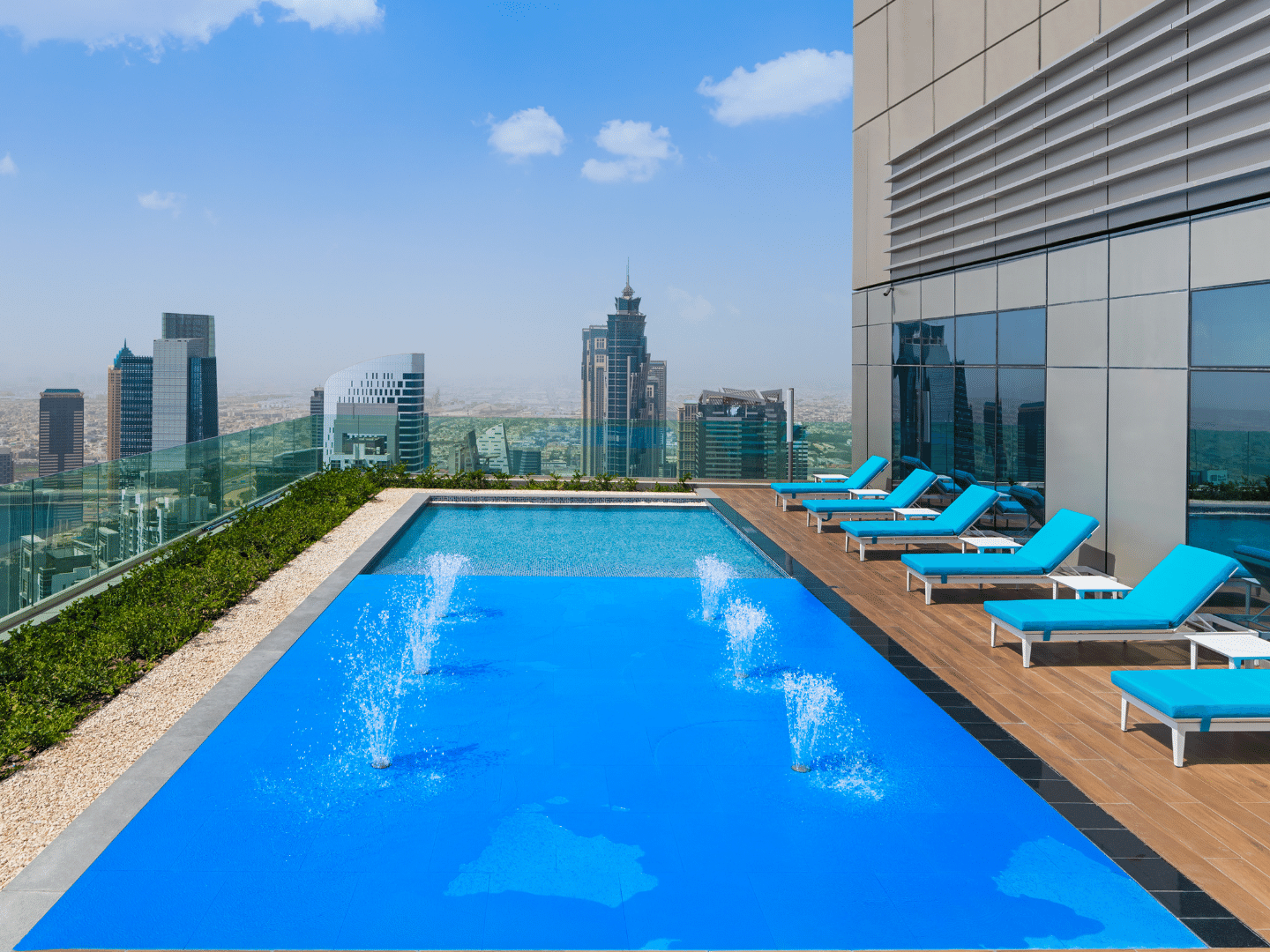 Sun loungers by the pool with city view in Malibu Sky Lounge & Bar at Paramount Hotel Midtown