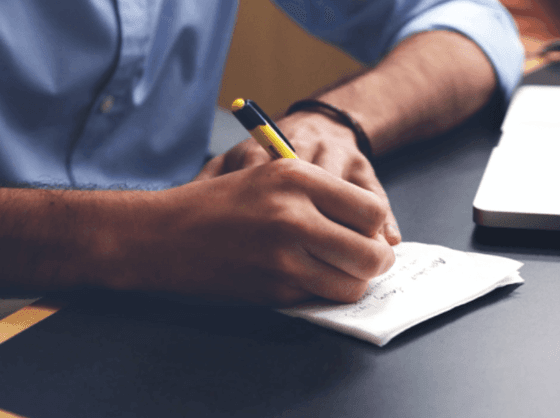 Closeup of a man writing notes at Richmond Hill Hotel