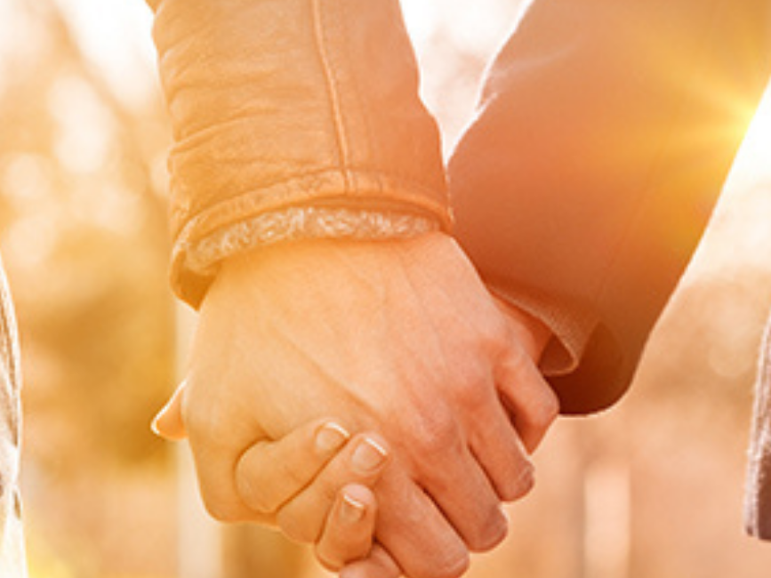 Closeup of a couple holding hands at Eagle Mountain House