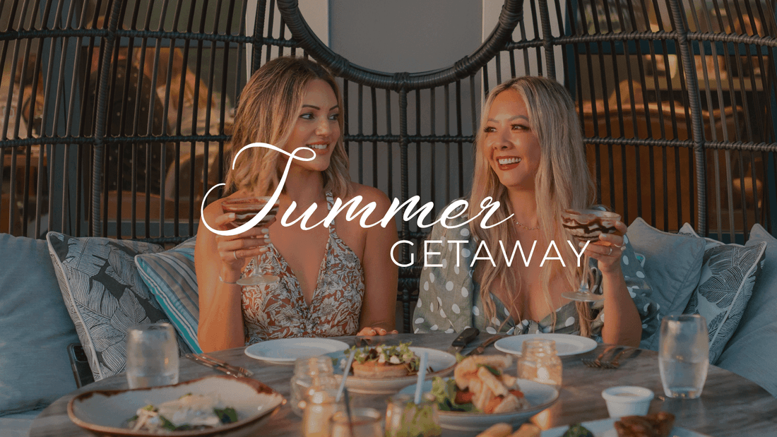 Two women enjoying a meal with wine glasses on a table with Summer Getaway text.