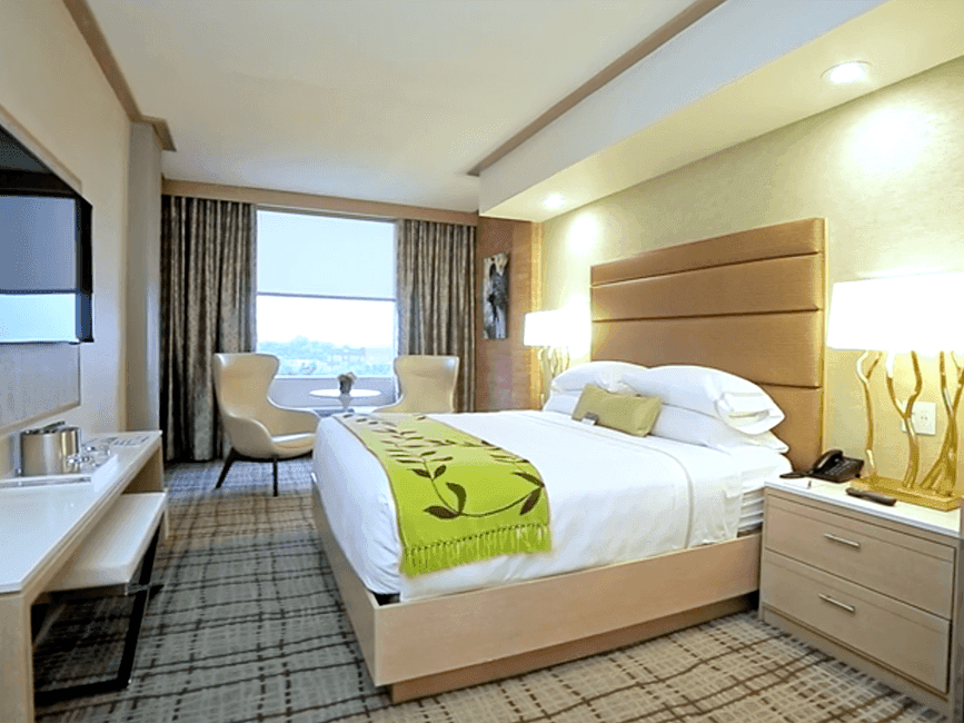 a bed and two chairs in a hotel room