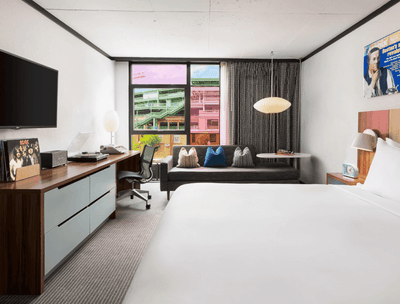 King bed, a TV, work desk, and cozy loungers in Standard King at The Verb Hotel