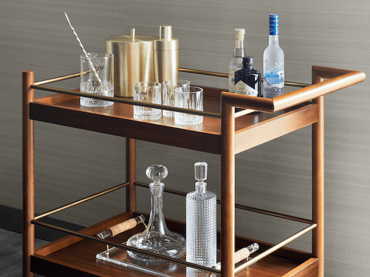 Bar Cart featuring glasses, liquor bottles, and a ice bucket in Gansevoort Suite at Gansevoort Meatpacking NYC