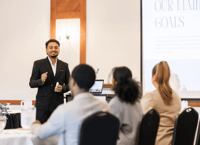 Business presenter speaking to seated guests during a professional meeting at Rodd Crowbush Golf & Beach Resort