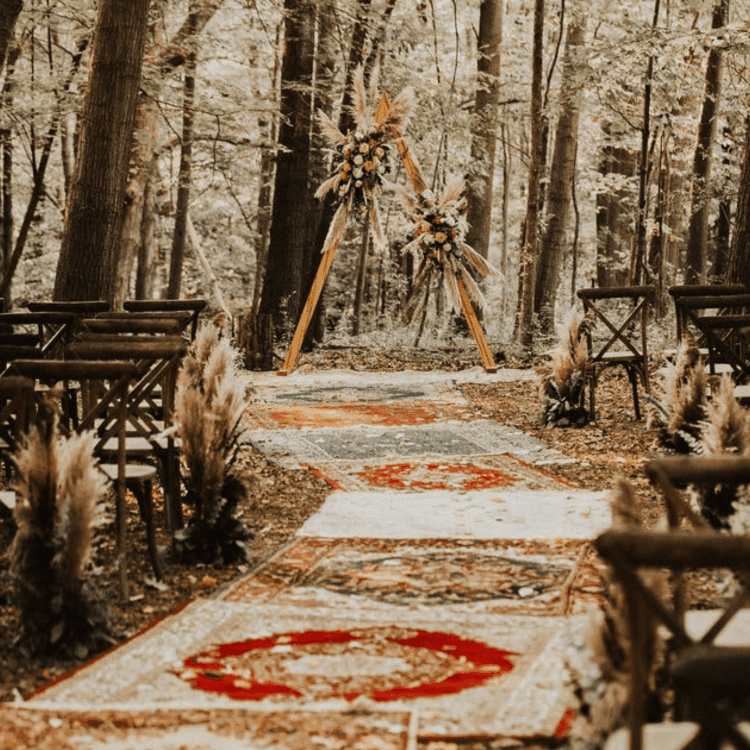 boho ceremony setup in woods