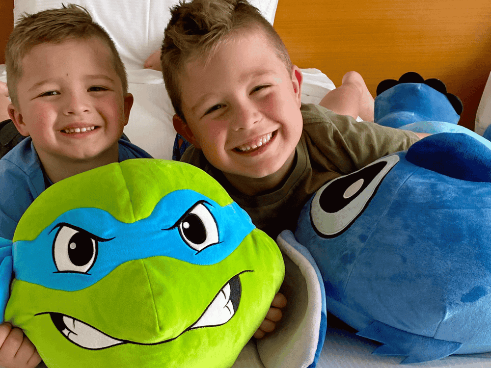 Kids having fun at Mercure with a Teenage Mutant Ninja Turtles plush and a blue plush.