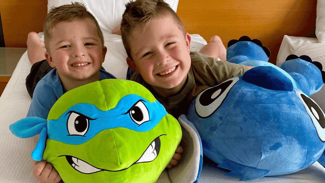 Kids having fun at Mercure with a Teenage Mutant Ninja Turtles plush and a blue plush.