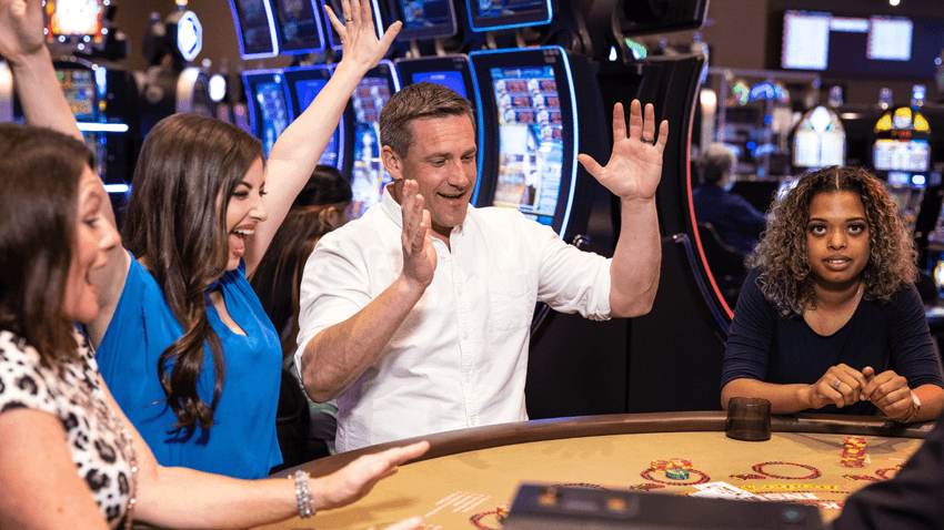 Group of people enjoying casino games near Pearl River Resorts