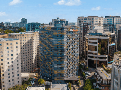 A modern urban skyline featuring UniLodge Auckland City among other buildings.