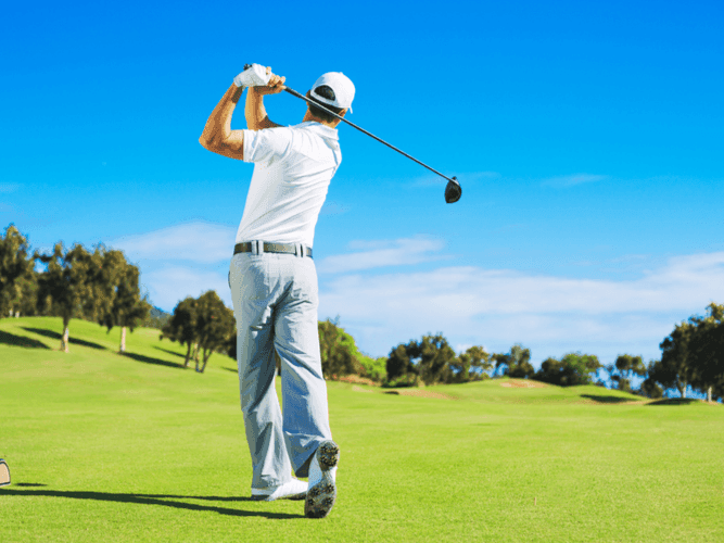 A man playing golf at the Golf Club in Mystic Dunes Resort