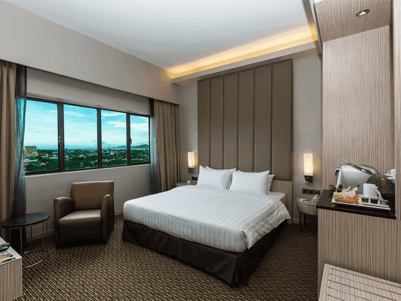 Wooden hangers and an Iron Board in Deluxe Plus King at Sunway Hotel Big Box