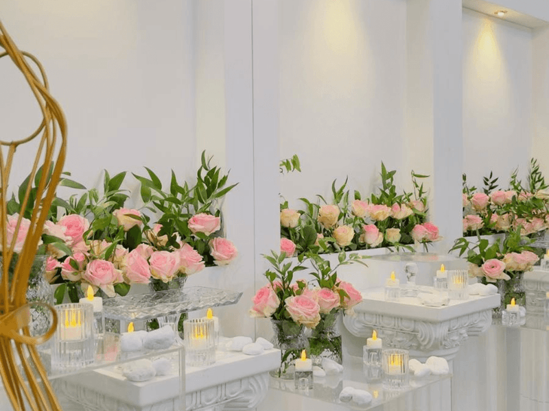 Elegantly decorated Coral Room with flowers and candles at Warwick Doha.