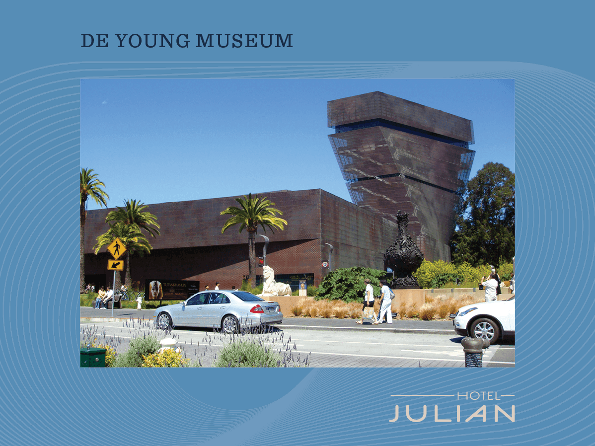 A photograph of a modern building with a unique design, palm trees, and a street with cars and people.