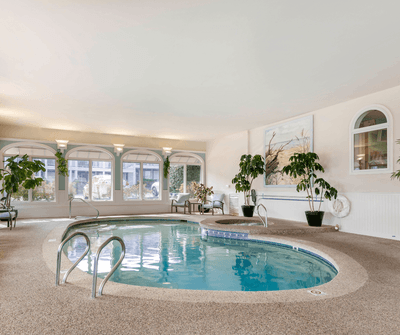 Indoor swimming pool with lounge seating at Anchorage By The Sea