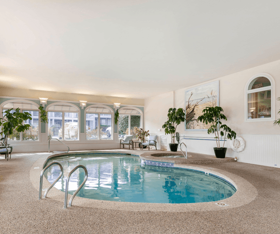 Indoor swimming pool with lounge seating at Anchorage By The Sea