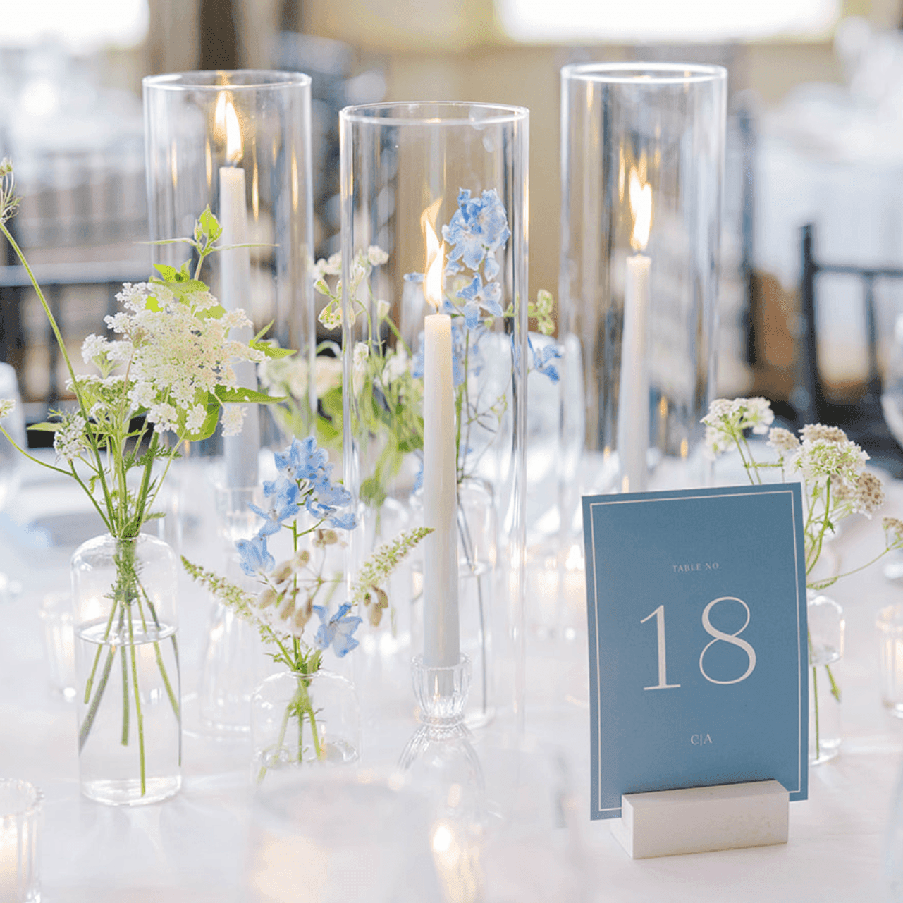 Close-up of banquet set-up with floral vases and candles in glass holders at Union Bluff Hotel