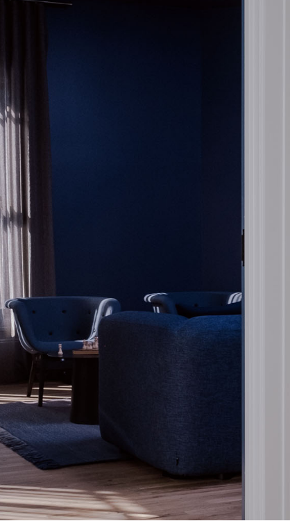 A private event room with a dark blue wall paint and sunny windows