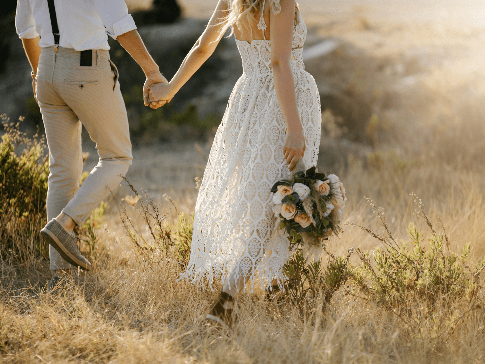Newlywed Couple walking through a flower field