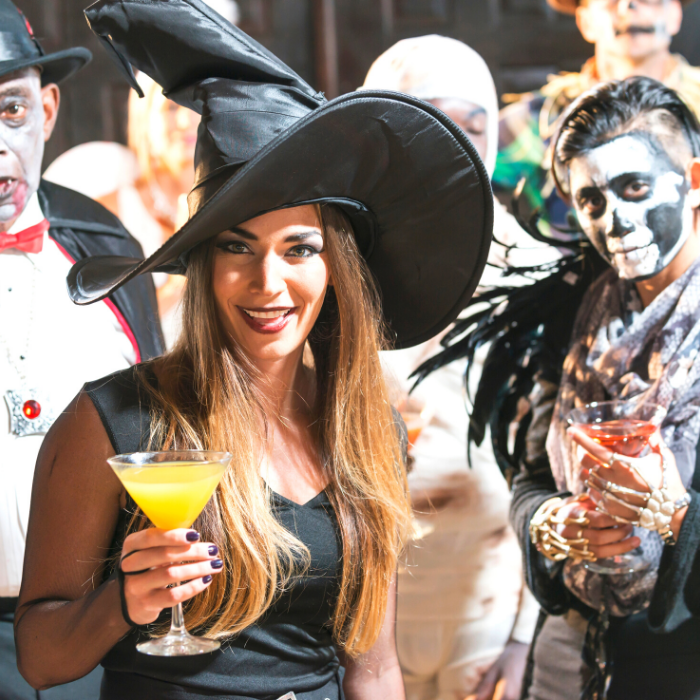 Adults in Halloween Costumes: Vampire, Witch, Skeleton in front. Fairy, Mummy, Scarecrow in back.