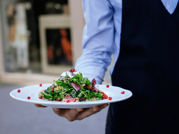 Closeup of a dish served by a waiter at Hotel Mont Gabriel