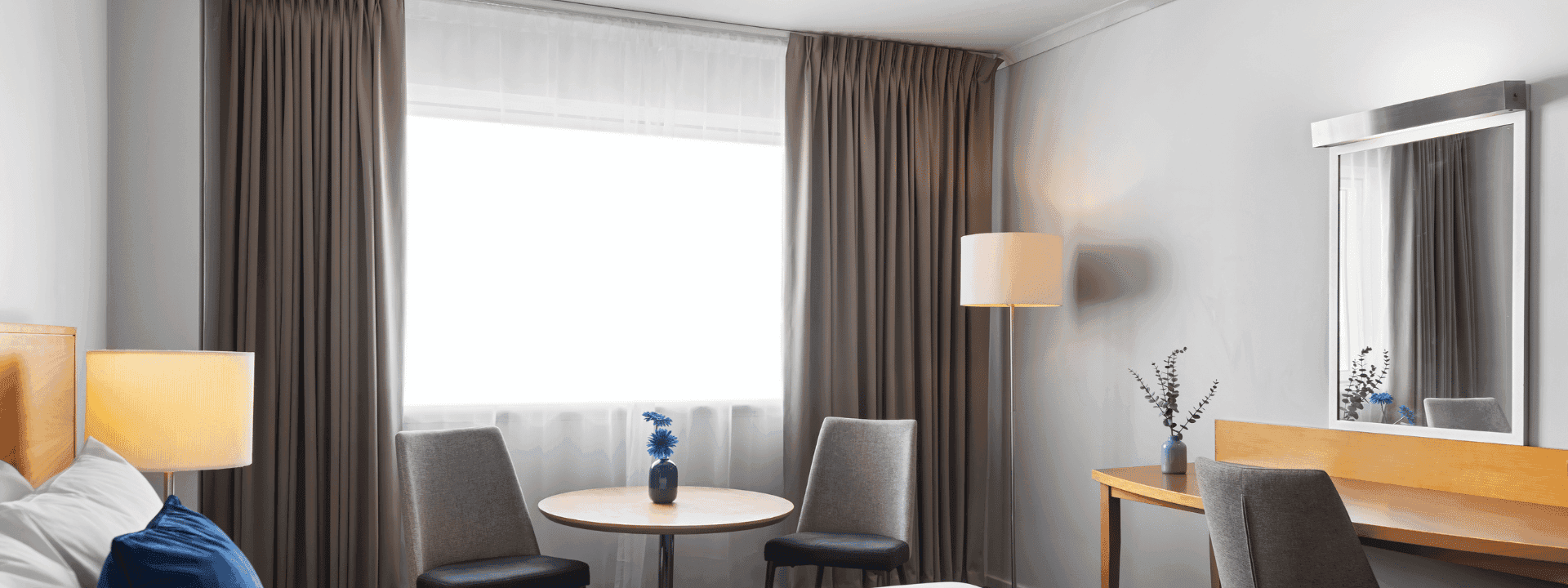 Novotel Perth Langley hotel's standard room with working desk, table and chairs.