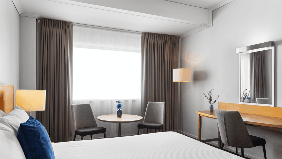 Novotel Perth Langley hotel's standard room with working desk, table and chairs.