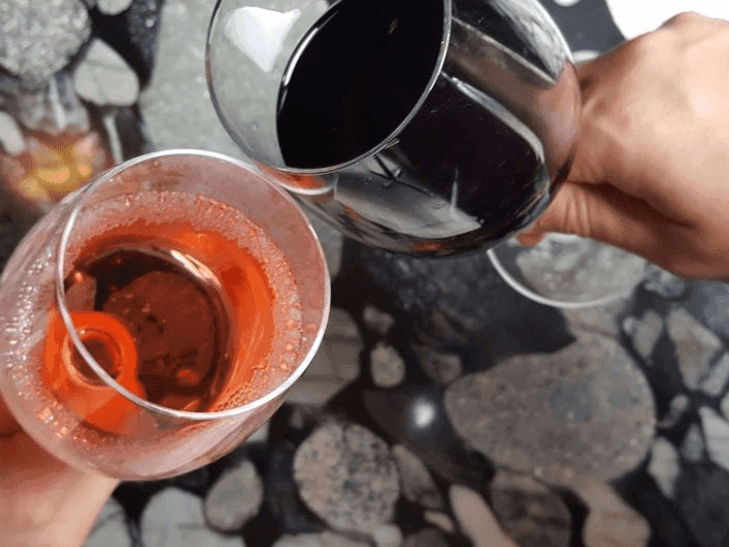 Close-up of toasting with two glasses of wine at Varscona Hotel on Whyte