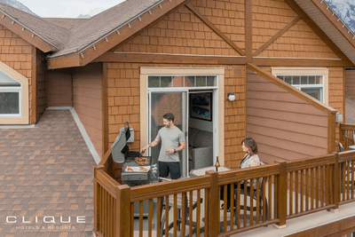 Couple enjoys the balcony of their suite at Falcon Crest Lodge overlooking the surroundings