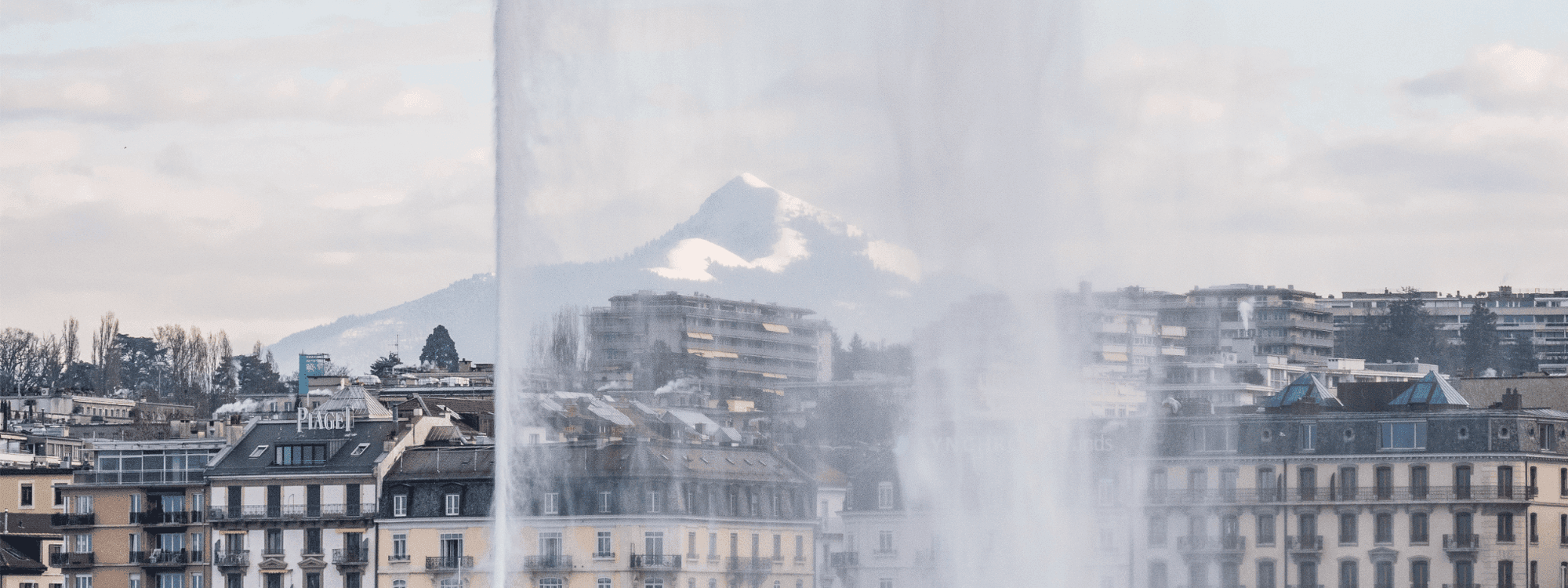 Water jet spraying high into the air above Lake Geneva.