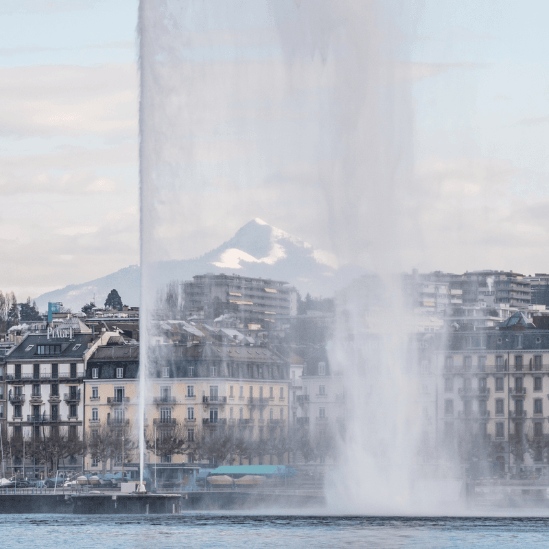 Water jet spraying high into the air above Lake Geneva.