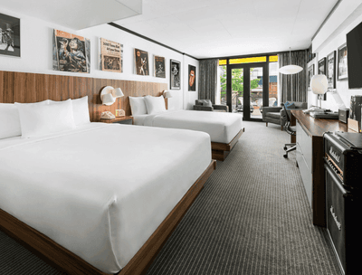 Workspace & lounger facing the beds in Deluxe Balcony Queen at The Verb Hotel