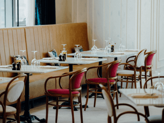 Dining tables arranged in Paparazzi Tuscan Restaurant at Paramount Hotel Midtown