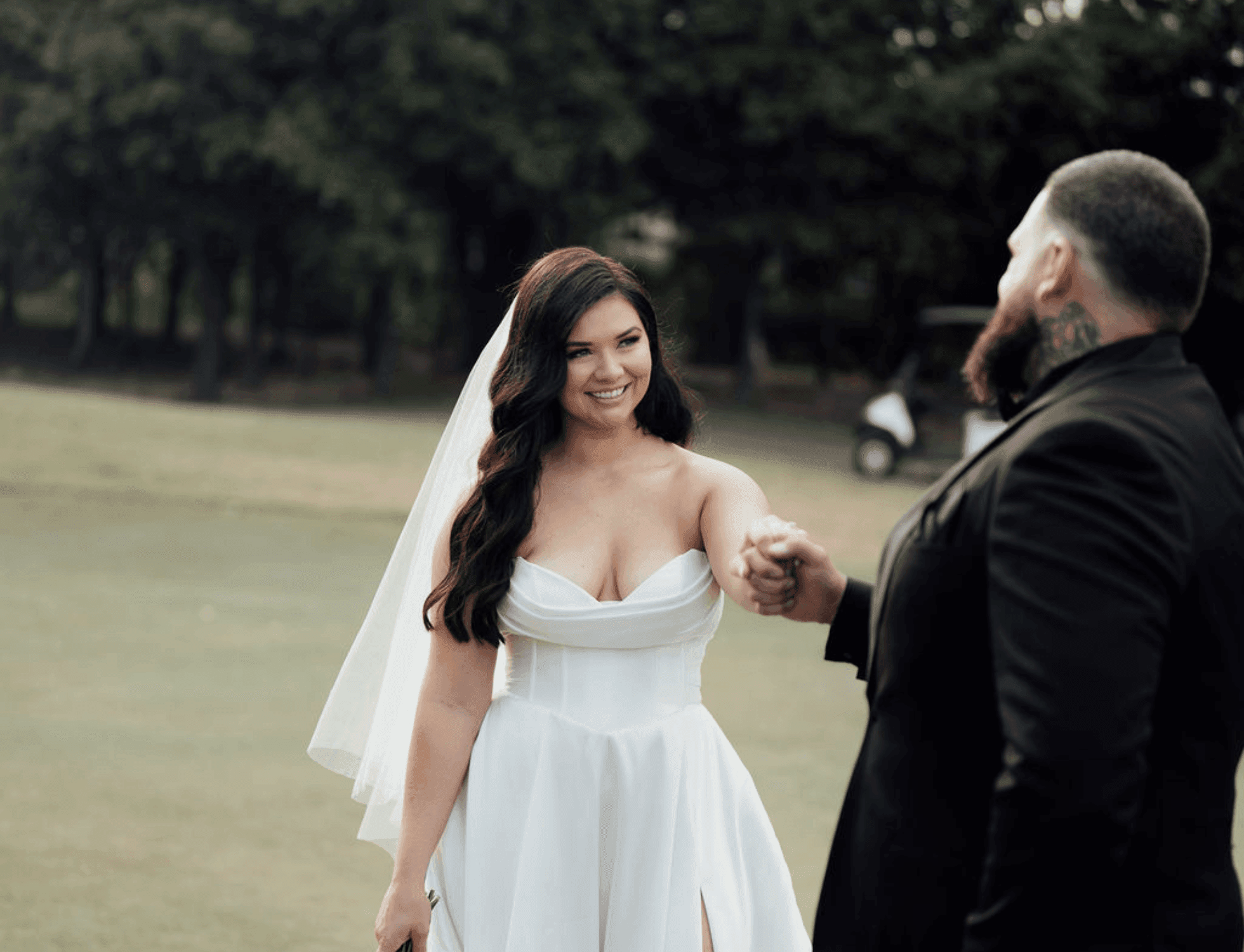 Bride and groom holding hands and smiling at Mercure Kooindah Waters.