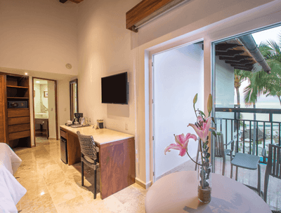 Working desk and a TV in Deluxe Two Double Beds Ocean View at Buenaventura Grand Hotel and Spa