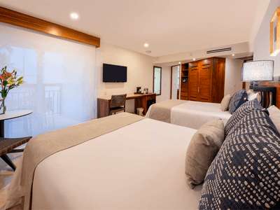 Family Deluxe Room with two comfy beds, TV, lamp and closet at Buenaventura Grand Hotel and Spa