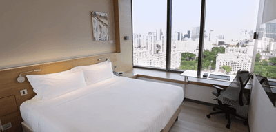 Workspace by the bed in The Mint Room with a city view at One Farrer Hotel