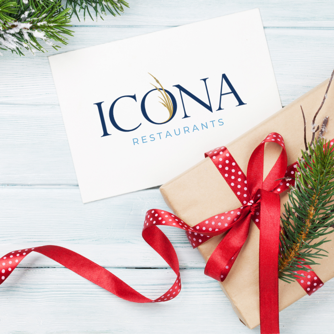 Gift card to our Avalon NJ hotel sitting on white table with holiday gift wrap.