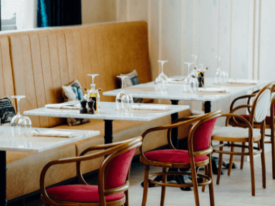 Dining tables arranged in Paparazzi Tuscan Restaurant at Paramount Hotel Midtown