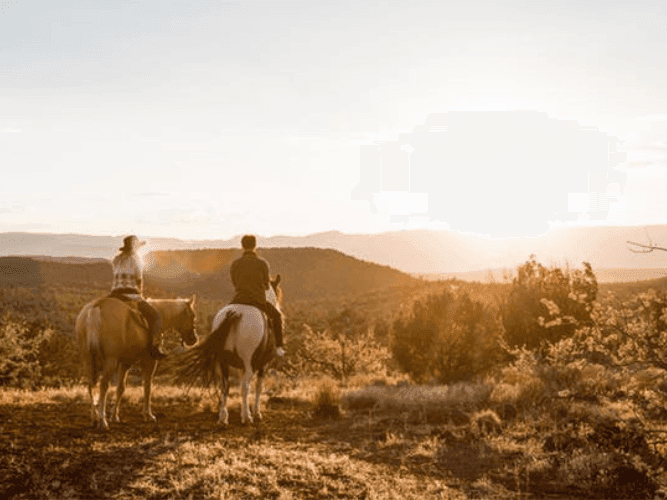 Two people horse riding at Diamond ranch