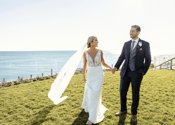 A wedded couple posing by the lawn at Pelham at Main