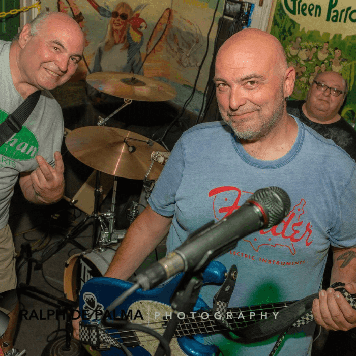 Juliano Brothers Band 3 older white men with guitar, bass, and drum set