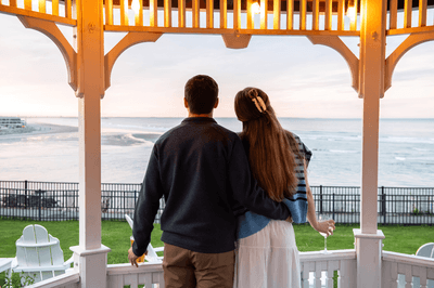 A couple enjoying the ocean view from a gazebo at Anchorage By The Sea