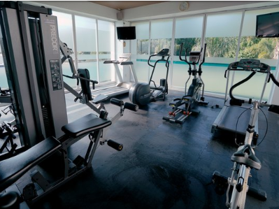 Interior of the gym with fitness machines at Gamma Hotels