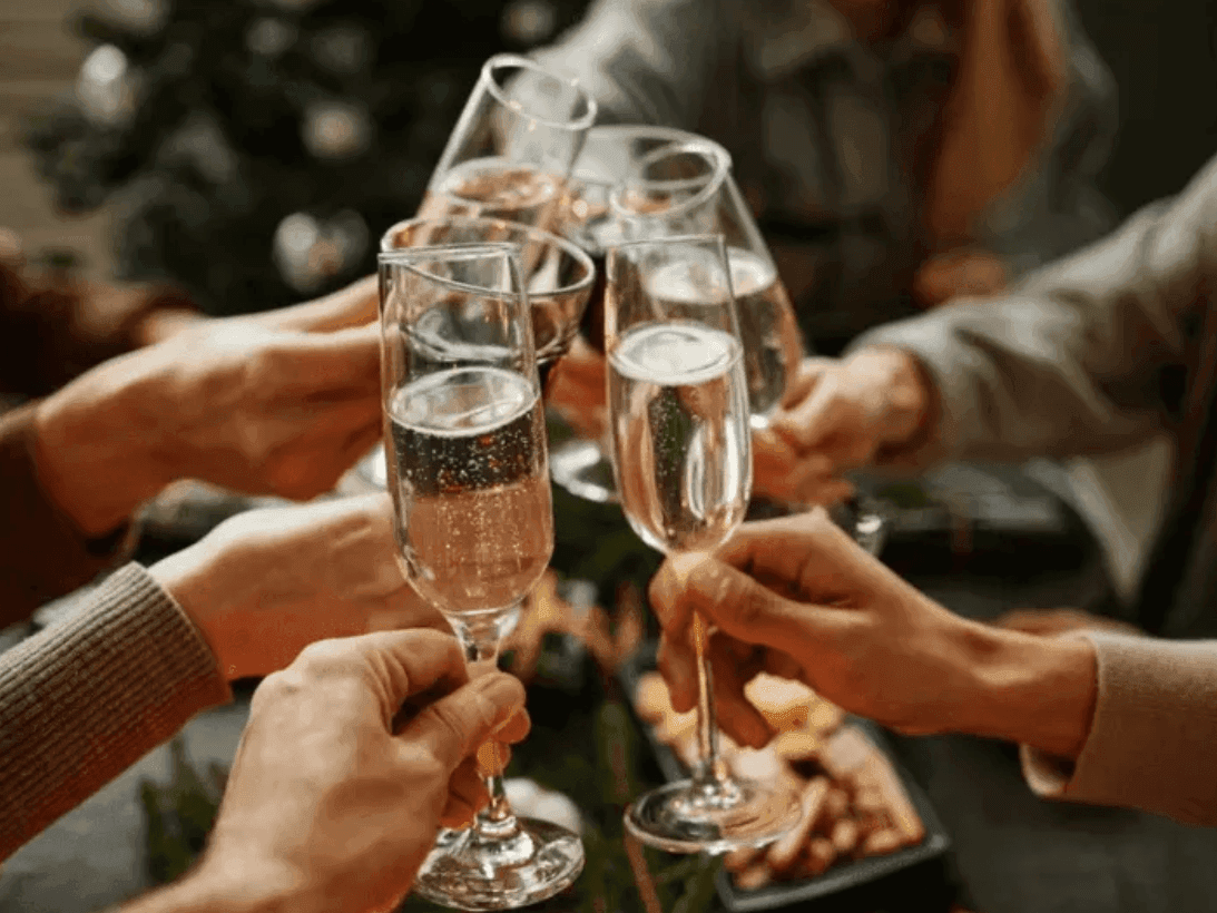Group of friends celebrating with a champagne toast during Canmore events at Spring Creek Resorts