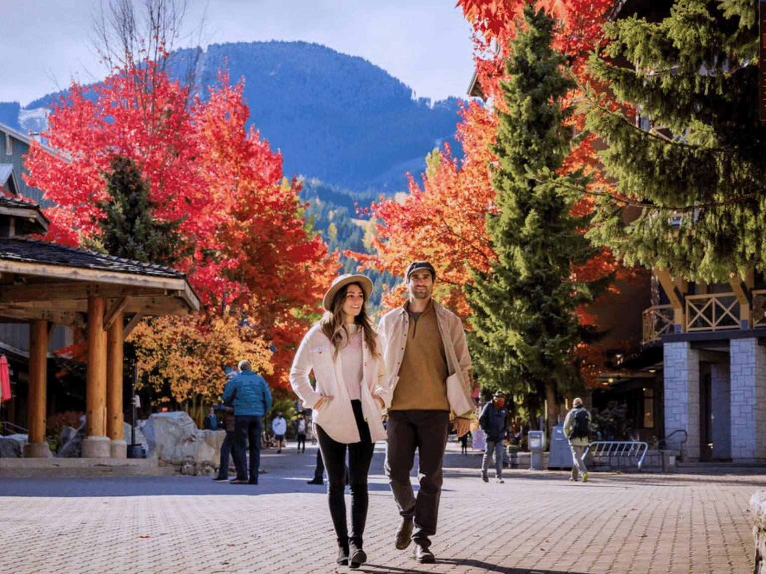 Fall: Couple walking in Whistler Village, enjoying the season's beauty.