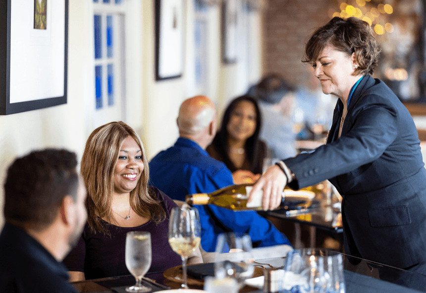 Server pouring wine for the guests at Vintage Restaurant in Inn at Willow Grove