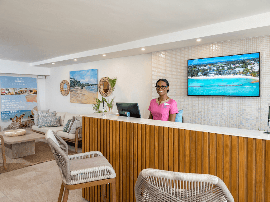 Receptionist with the arranged lobby area at Sugar Bay Barbados