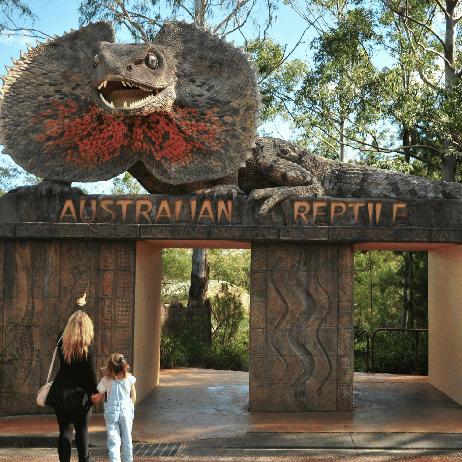 The Ultimate Family Gift poster with lady holding an animal in the background at Mercure Kooindah Waters