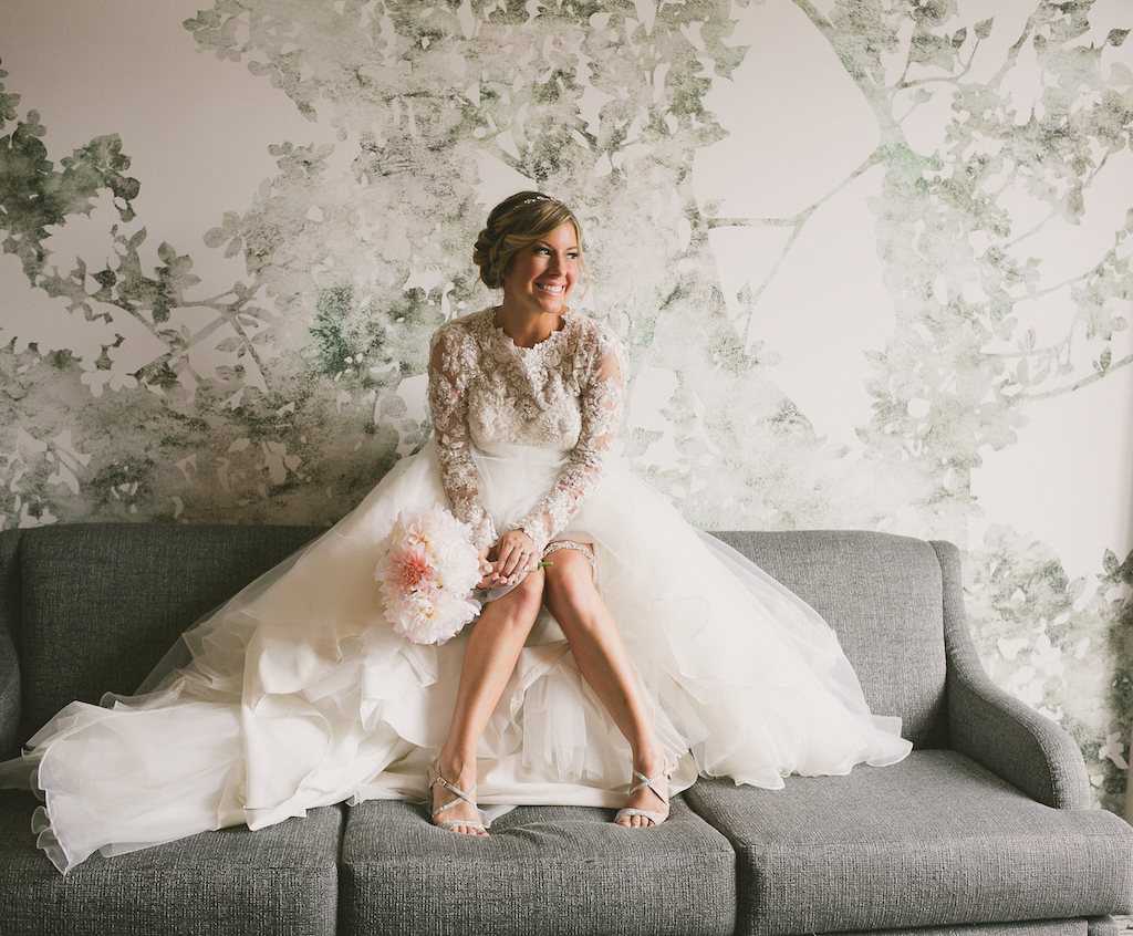 Bride sitting on a sofa at The Grove Hotel